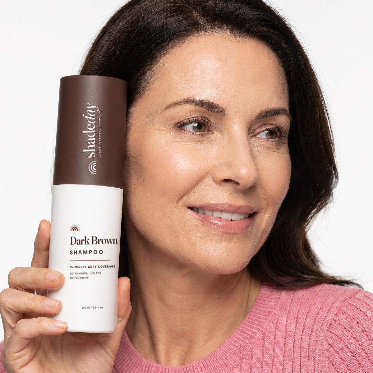 Woman holding Shadeday Dark Brown shampoo